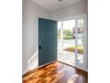 Inviting entryway featuring hardwood floors, a blue front door, and bright natural light at 104 Mainline Sta, Morrisville, NC 27560