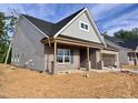 Side view of an attractive home with brick and vinyl siding and unfinished yard at 1073 Fairhaven Dr # 52, Mebane, NC 27302