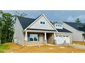 Stylish brick and siding home with an attached two-car garage and inviting entrance at 1073 Fairhaven Dr # 52, Mebane, NC 27302