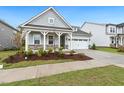Lovely home with a well-manicured lawn, two-car garage, and inviting curb appeal at 1116 Ciandra Barn Way, Apex, NC 27523