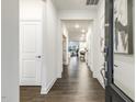 Bright hallway with hardwood floors and views into the dining and living areas at 1116 Ciandra Barn Way, Apex, NC 27523