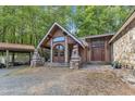 Charming home featuring a covered entryway with stone accents and statues, surrounded by a gravel driveway at 11209 Sedgefield Dr, Raleigh, NC 27613