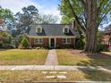 Traditional brick home with a landscaped front yard and inviting brick walkway at 119 Montgomery St, Raleigh, NC 27607