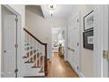 Inviting hallway showcasing hardwood floors and staircase leading upstairs at 119 Montgomery St, Raleigh, NC 27607