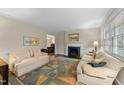 Cozy living room featuring fireplace, neutral walls, and decorative rug at 119 Montgomery St, Raleigh, NC 27607