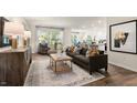 Open-concept living room with modern decor, stylish furniture, and ample natural light creating an inviting atmosphere at 1216 Pavo Path, Wendell, NC 27591