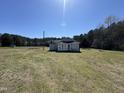 Exterior rear view of a home, showing the back of the house and yard at 1278 Valley Ct, Zebulon, NC 27597