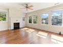 Sun-drenched living room features a decorative fireplace and hardwood floors with lots of windows at 1308 Wake Forest Rd, Raleigh, NC 27604