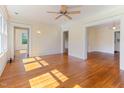 Bright living room with hardwood floors, large windows, and classic architectural details at 1308 Wake Forest Rd, Raleigh, NC 27604
