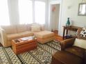 Comfortable living room featuring a sectional sofa, patterned rug, and lots of natural light at 1308 Wake Forest Rd, Raleigh, NC 27604