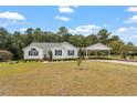 Traditional home featuring white siding, black shutters, a covered carport, and a well-manicured lawn at 132 Crystal Pl, Benson, NC 27504