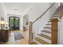 Welcoming foyer with hardwood floors, staircase, and stylish decor, leading into the home at 143 Sallyport Ct, Raleigh, NC 27603