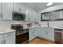 Beautiful kitchen featuring stainless appliances, shaker cabinets, and quartz countertops at 1535 Caraleigh Mills Ct # 104, Raleigh, NC 27603