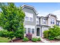 Inviting two-story townhome featuring lush landscaping and a well-maintained facade at 1817 Shady Oaks Dr, Wendell, NC 27591