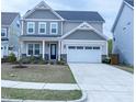 Charming two-story home with a two-car garage and manicured front lawn at 1950 Menet St, Apex, NC 27502