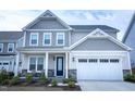 Charming two-story home with a two-car garage, covered porch, and manicured front lawn at 1950 Menet St, Apex, NC 27502