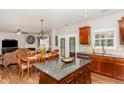 Open kitchen with granite countertops, stainless steel appliances, breakfast bar, and adjacent dining area at 2317 Rainy Lake St, Wake Forest, NC 27587