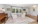 Cozy living area with chairs, a patterned rug, and a view of the outdoors at 2960 Epps Clark Rd, Siler City, NC 27344