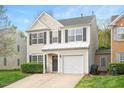 Charming two-story home with well-maintained landscaping, gray door and black shutters, plus an attached one-car garage at 308 Apricot Cir, Morrisville, NC 27560