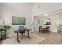 Open-concept living space with soaring ceilings, wood floors, with designated area for work and dining space at 308 Apricot Cir, Morrisville, NC 27560