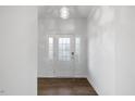 Bright foyer with white walls, tiled floors, and elegant glass-paneled front door at 3735 Landshire View Ln, Raleigh, NC 27616
