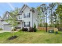 Well-maintained two-story home with a spacious, lush green lawn and mature landscaping at 375 Alcock Ln, Youngsville, NC 27596