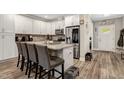 Bright kitchen with an island, granite countertops, stainless appliances and vinyl plank flooring at 375 Alcock Ln, Youngsville, NC 27596