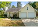 Charming home with a two-car garage, meticulously landscaped front yard, and well-maintained lawn at 378 E Raleigh Ave, Liberty, NC 27298