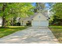 Charming home with a two-car garage, a well-maintained lawn, and mature trees at 378 E Raleigh Ave, Liberty, NC 27298