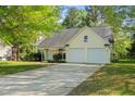 Inviting home showcasing a well-manicured lawn, a two-car garage, and classic exterior finishes at 378 E Raleigh Ave, Liberty, NC 27298
