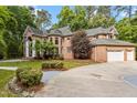 Beautiful brick home featuring an attached garage and a well-manicured lawn with mature trees at 417 Swans Mill Xing, Raleigh, NC 27614