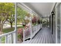Covered front porch with white columns and railings, overlooking the front yard and neighborhood at 5033 Knightsbridge Way, Raleigh, NC 27604