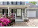 Close-up of the front porch with white railings and steps, leading to a front door at 5033 Knightsbridge Way, Raleigh, NC 27604