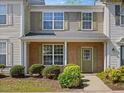 Inviting townhouse displaying a brick front, complemented by green shutters and neat landscaping at 5044 Brooke Lauren Ln, Raleigh, NC 27616