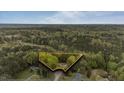Overhead view showcasing the lot with mature trees surrounding the charming single-story home at 5064 Murrell Dr, Oxford, NC 27565