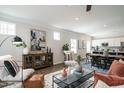 Spacious living area flowing into the kitchen with a stylish glass coffee table at 52 E American Marigold Dr # 63, Benson, NC 27504
