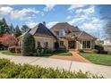 Charming brick home with manicured landscaping and an inviting brick walkway to the front entrance at 595 Legacy Falls N Dr, Chapel Hill, NC 27517