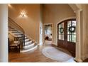 Inviting foyer with a curved staircase, hardwood floors, and a view into a cozy living space at 595 Legacy Falls N Dr, Chapel Hill, NC 27517
