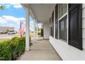 Covered front porch showcases stately columns, black shutters, and lush landscaping at 713 Catherine Lake Ct, Fuquay Varina, NC 27526