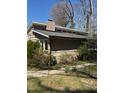 A charming home exterior featuring a brick chimney and window features at 748 Currituck Dr, Raleigh, NC 27609