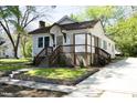 Quaint two-story home with inviting front porch, manicured lawn, and traditional architectural details at 808 Grace Ave, Burlington, NC 27217