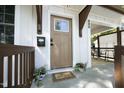 Close-up of the front door and porch, highlighting the secure keypad and lovely plants at 808 Grace Ave, Burlington, NC 27217