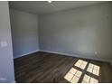 Bright bedroom featuring hardwood floors, ample natural light, and neutral walls at 84 Grove Township Way, Angier, NC 27501