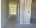 Light-filled entryway showcasing neutral walls and carpet leading to a bright living space at 84 Grove Township Way, Angier, NC 27501