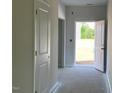 Hallway with an open door to the outside, providing natural light and inviting access to outdoor spaces at 84 Grove Township Way, Angier, NC 27501