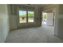 This room offers a view of the outdoors, highlighted by the natural light from the large windows at 84 Grove Township Way, Angier, NC 27501