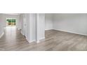 Bright living space featuring modern gray wood flooring, fresh white trim, and lots of natural light at 84 Grove Township Way, Angier, NC 27501