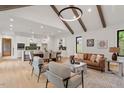 Open concept living area with hardwood floors, vaulted ceiling, and exposed wooden beams at 1007 E Davie St, Raleigh, NC 27601