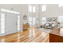 Airy living room featuring high ceilings, natural light, a comfortable seating area, and elegant furnishings at 101 Vista Brooke Dr, Morrisville, NC 27560