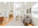 Bright living room with soaring ceilings, large windows, hardwood floors, and a cozy seating area with stylish decor at 101 Vista Brooke Dr, Morrisville, NC 27560